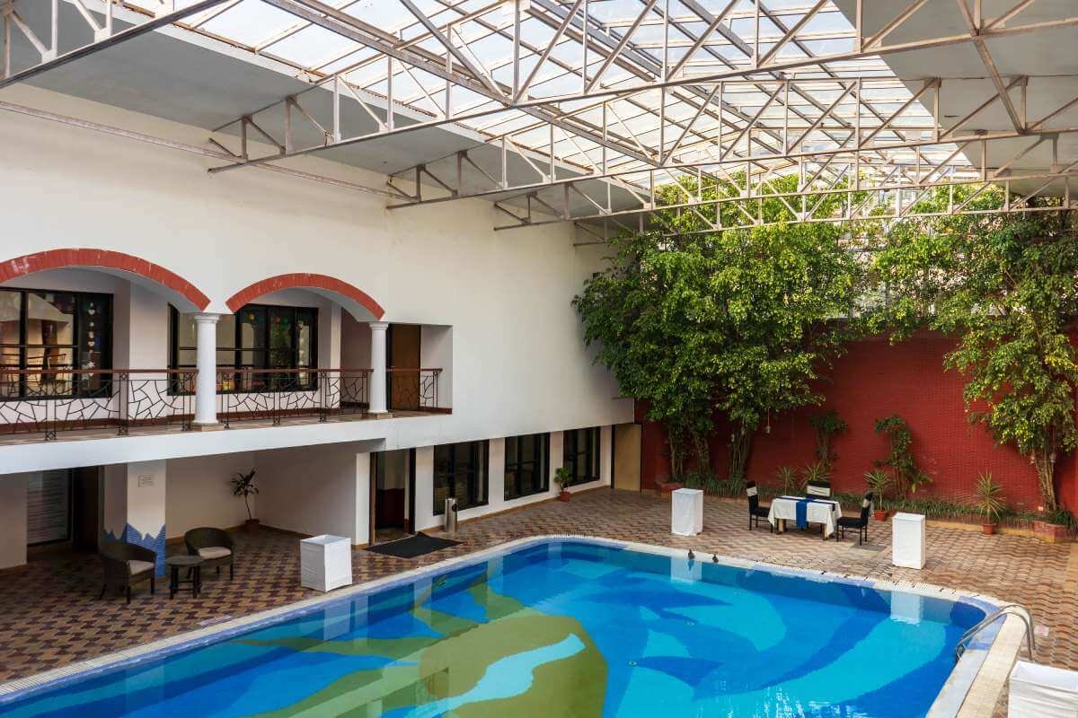 Country Inn Bhimtal retreat grounds with swimming pool and greenery
