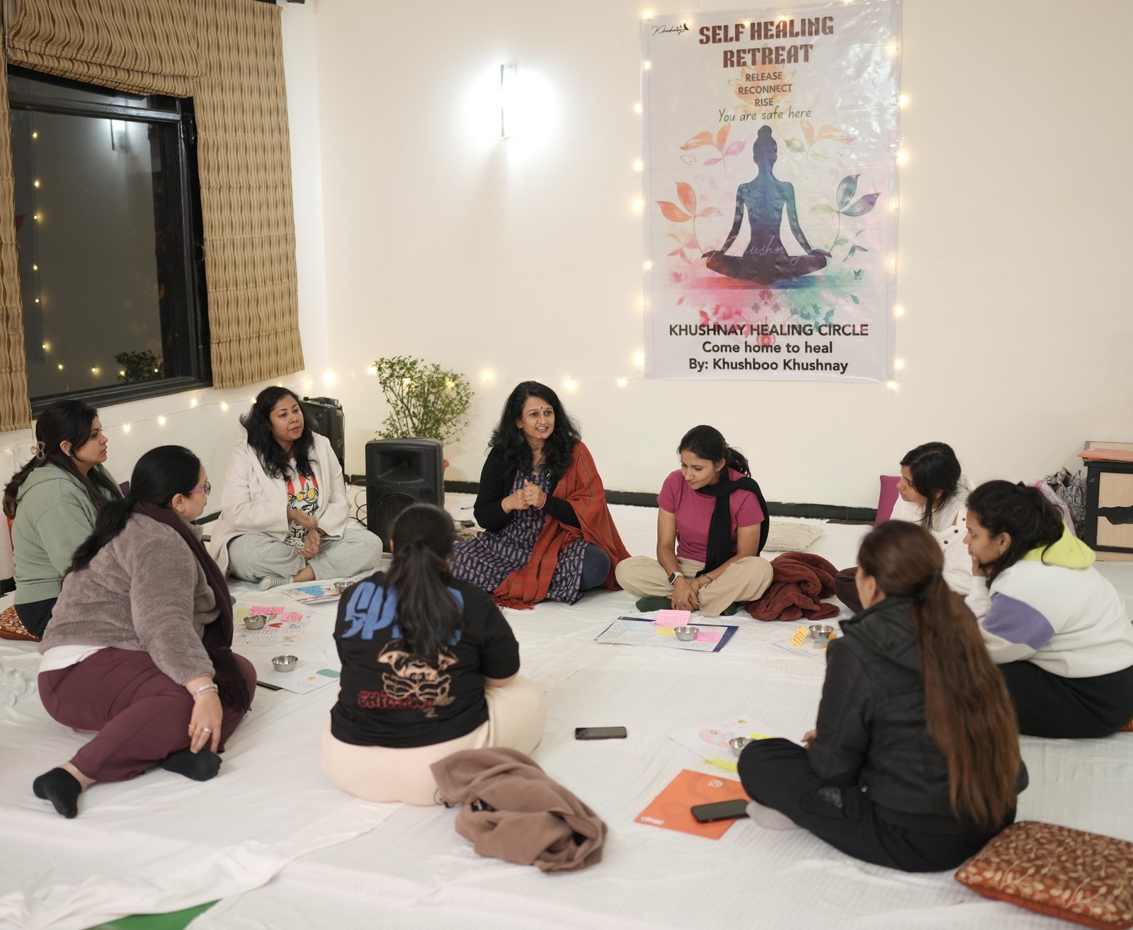 Intimate group circle gathered for meditation and somatic work